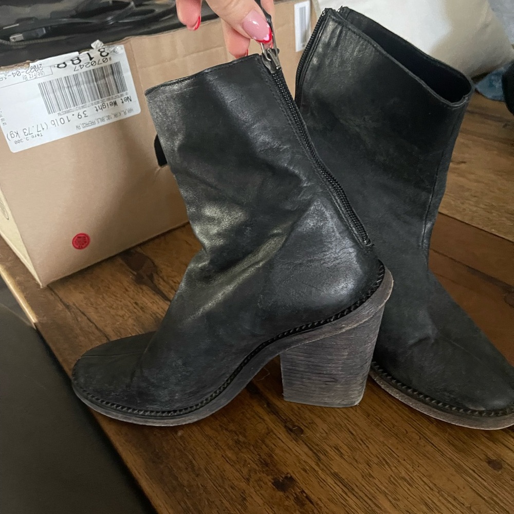 Black heeled boots with zipper closure
